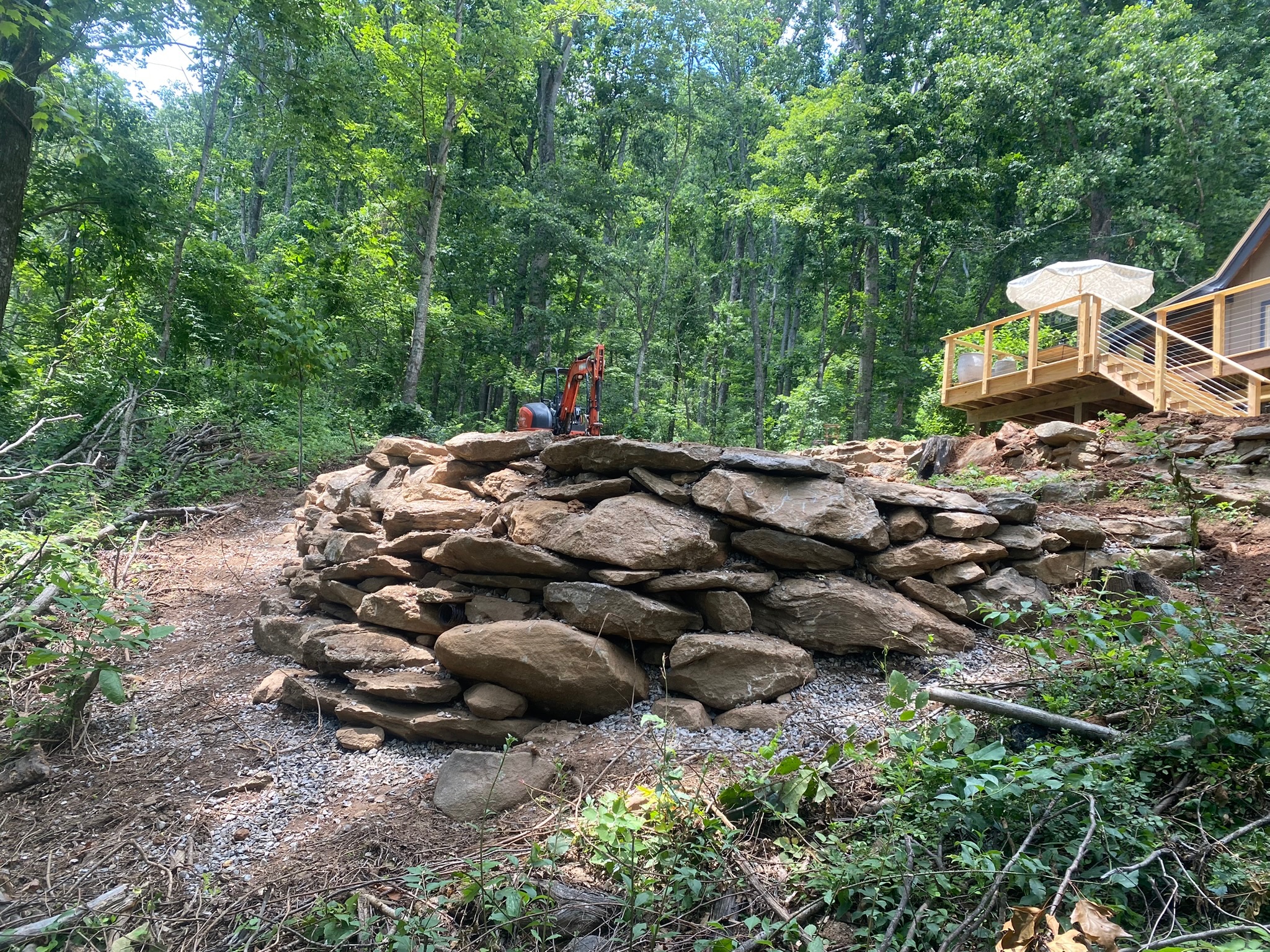 Stone retaining wall with cabin deck